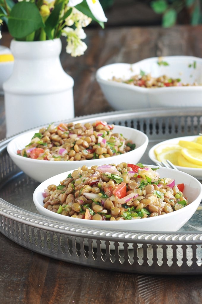 Cette salade de lentilles à la marocaine est délicieusement parfumée au cumin, coriandre et menthe. Très simple et facile à faire. Composée de lentilles, tomates, oignon et une vinaigrette toute simple. A servir tiède ou froide, en entrée ou en plat d’accompagnement pour vos viandes et poissons grillés.