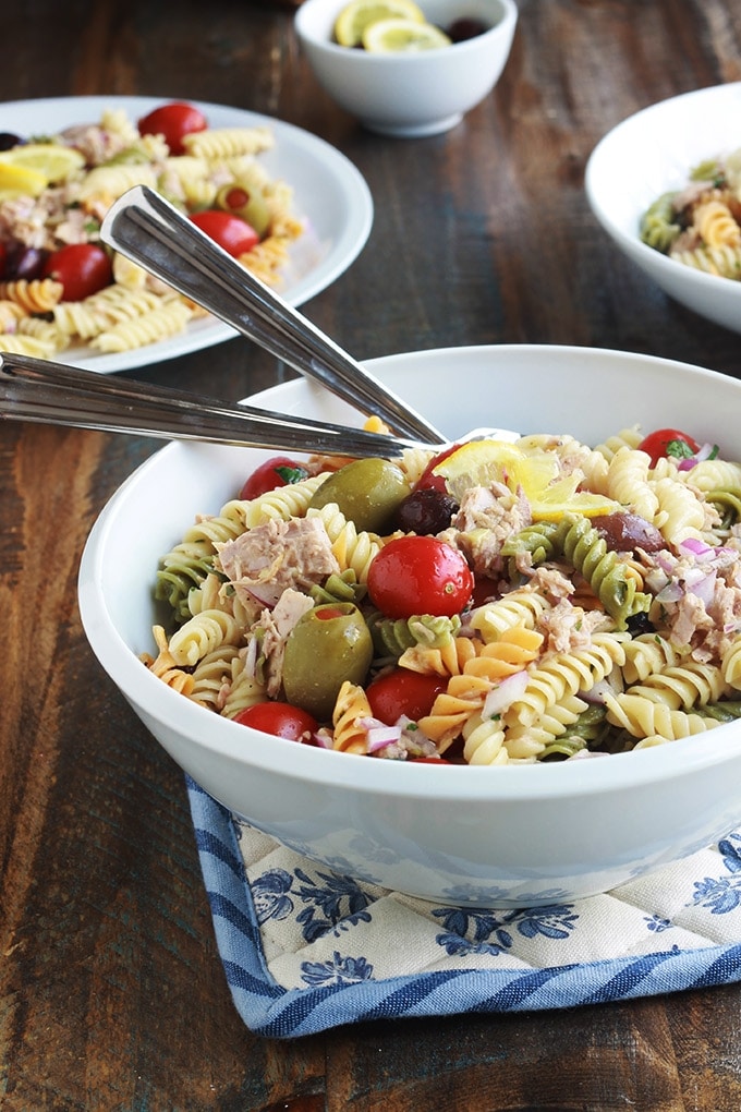 Délicieuse salade de pâtes au thon toute simple, parfumée, avec une vinaigrette aux herbes fines. Une recette facile et rapide à faire.  C'est une salade repas froide, parfaite pour l'été. Composée de pâtes fusilli 3 couleurs, thon en boîte, tomates, oignon, olives, vinaigrette aux herbes aromatiques.