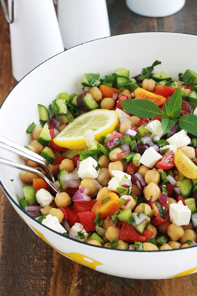 Salade de pois chiches à la grecque rafraîchissante. Une recette facile et rapide (5 minutes!). Des pois chiches, tomates, concombres, oignons, feta, olives kalamata et aromates. Le tout arrosé d’une vinaigrette grecque toute simple. C’est une salade économique, végétarienne et vegan (sans la feta!).