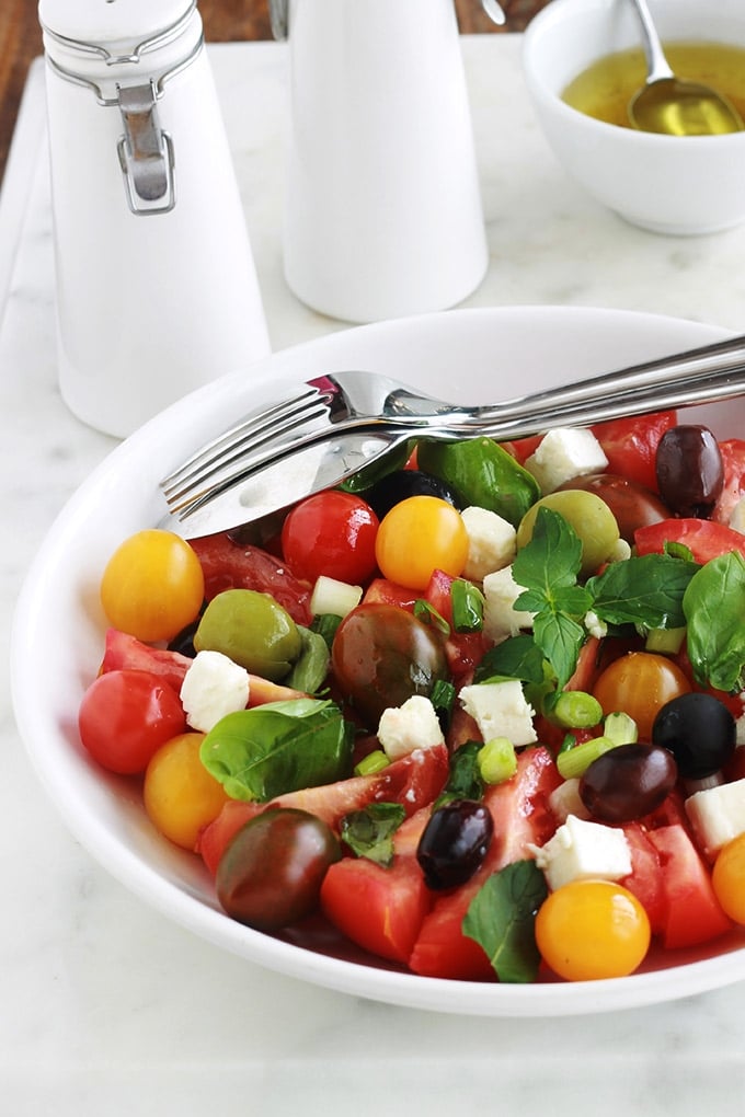 Délicieuse salade de tomates avec du fromage feta, des olives et du basilic. Le tout arrosé d’une vinaigrette toute simple. C’est l’une de mes salades estivales préférées, très parfumée, facile et rapide.