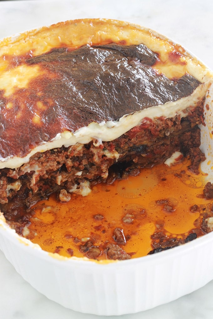 La recette de la moussaka grecque facile. Un délicieux gratin complet avec des aubergines, sauce tomate à la viande hachée et sauce blanche. Je vous donne une recette de base toute simple et plusieurs façons de varier / simplifier ce plat réconfortant.