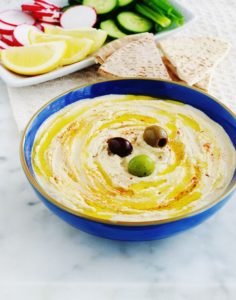 La recette du houmous libanais : une délicieuse purée de pois chiches au tahiné (crème de sésame). Peu d'ingrédients : pois chiches, tahiné, ail, jus de citron. Pour servir : de l'huile d'olive et éventuellement des épices, herbes fines, crudités, pain pita. Le houmous maison est tellement meilleur que celui du commerce, et en plus il est facile et rapide : prêt en moins de 5 minutes!