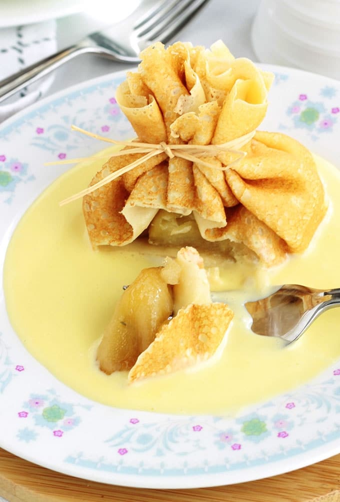 Délicieux dessert tout simple, chic et méga gourmand! Des aumônières de crêpes garnies de pommes caramélisées et présentées sur un fond de crème anglaise. La recette est très facile et vous pouvez préparer à l’avance les pommes caramélisées et la sauce pour sucrée. Superbes comme dessert pour votre repas de Noel ou de fin d'année!