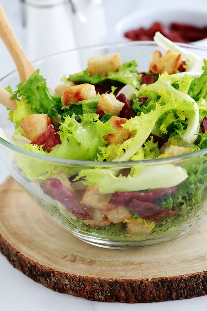 Salade frisée (ou chicorée frisée) toute simple avec des croûtons et des lardons fumés de dinde. C’est ma salade verte préférée, croquante avec parfois un petit goût amer. Je vous donne quelques idées pour varier votre salade.