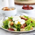 Salade frisée aux oeufs pochés, croûtons croustillants et lardons fumés de dinde. Recette simple et délicieuse. Peut servir de plat principal rapide et léger.