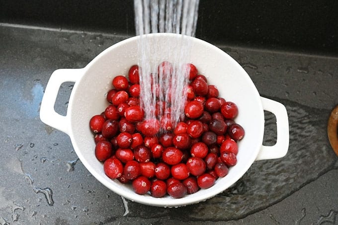 Cranberries dans une passoire sous l'eau du robinet