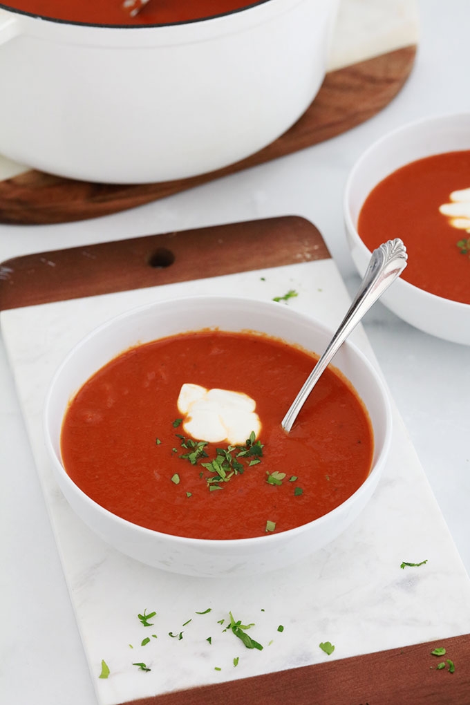Soupe de tomates maison dans deux bols et dans cocotte en fonte.